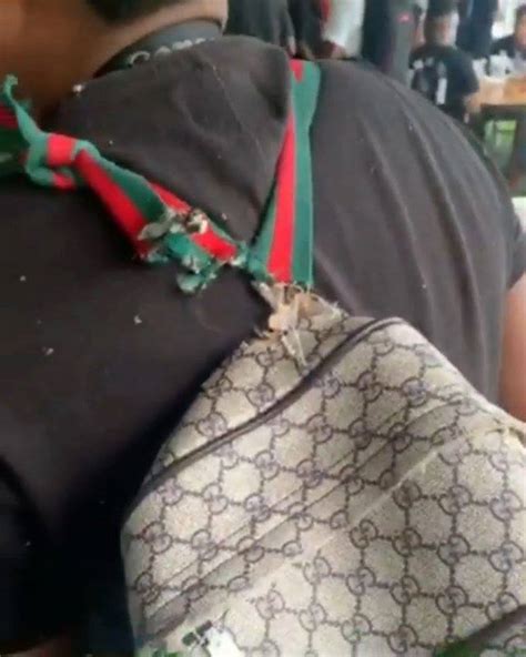 gucci bag hanging on by a thread